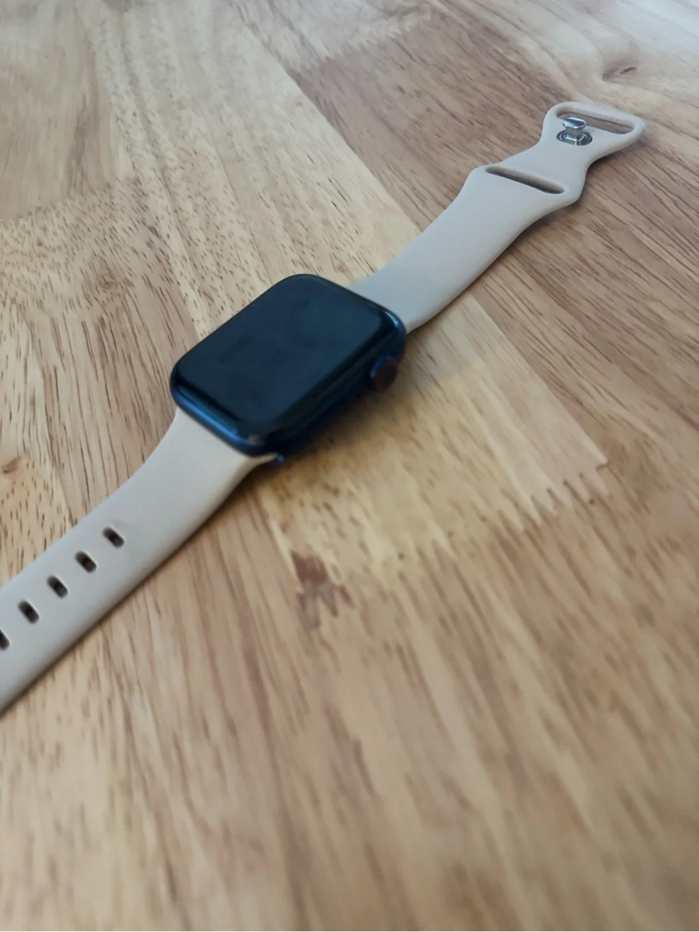 Apple Smartwatch with Light Beige Silicone Band and Black Face